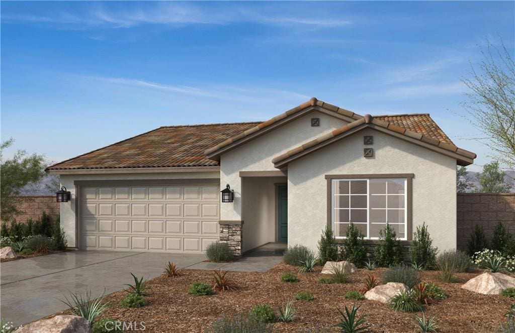 view of front facade featuring stucco siding, a tile roof, concrete driveway, and an attached garage