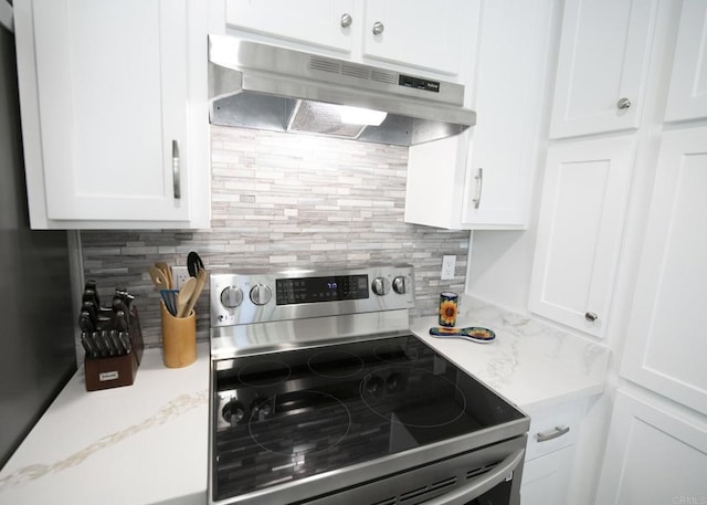 kitchen featuring decorative backsplash, white cabinetry, light stone countertops, and electric stove