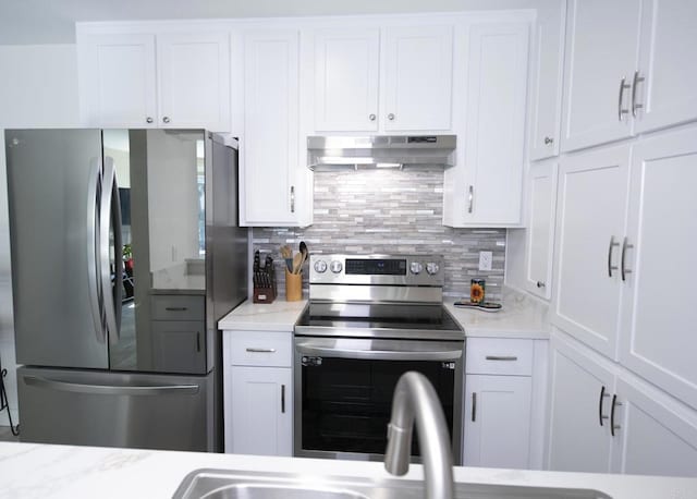 kitchen featuring white cabinetry, backsplash, and appliances with stainless steel finishes