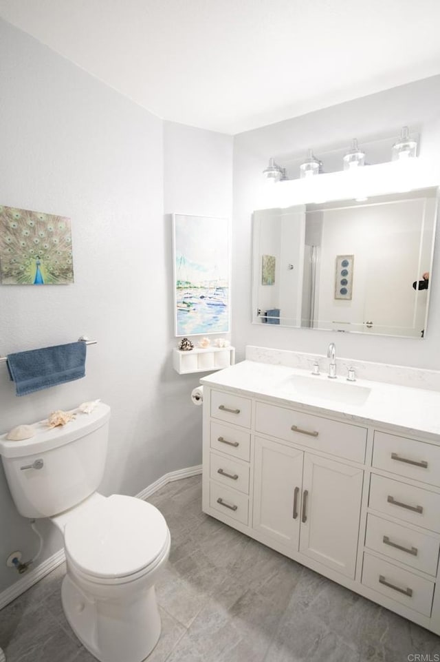 bathroom with tile patterned floors, vanity, and toilet