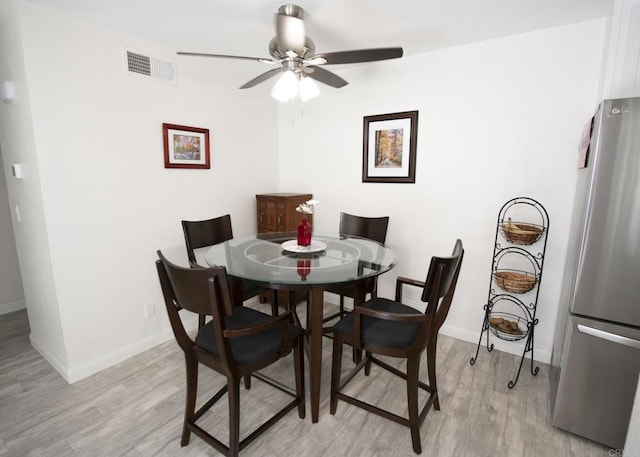 dining space featuring ceiling fan and light hardwood / wood-style floors