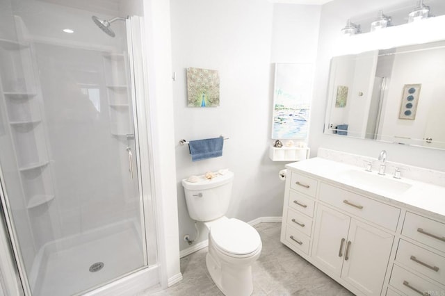 bathroom featuring tile patterned floors, vanity, toilet, and walk in shower