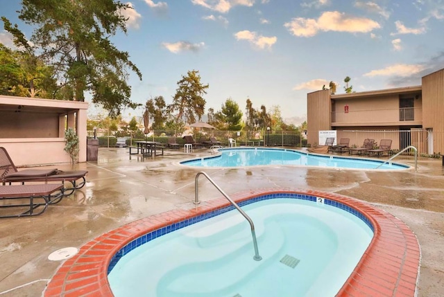 view of pool featuring a patio area and a community hot tub