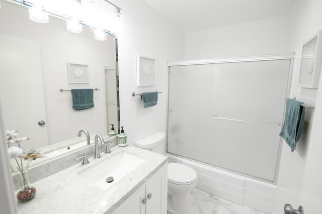 full bathroom featuring vanity, toilet, and bath / shower combo with glass door