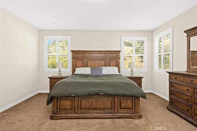 carpeted bedroom featuring baseboards