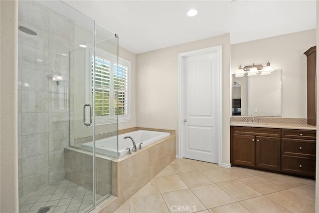 full bathroom with vanity, a bath, a shower stall, and tile patterned flooring