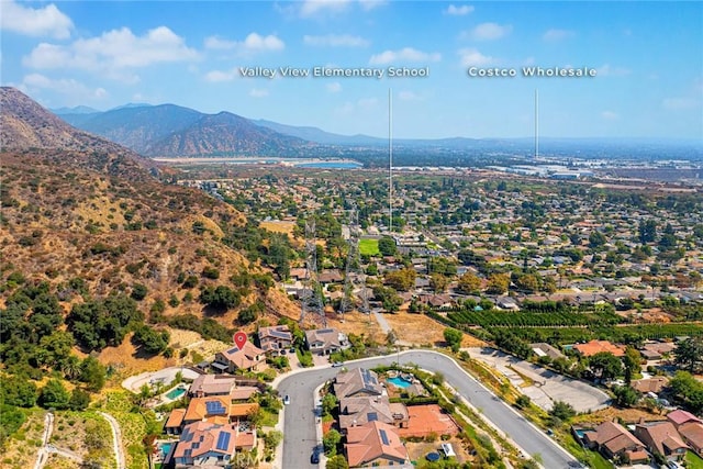 drone / aerial view featuring a residential view and a mountain view