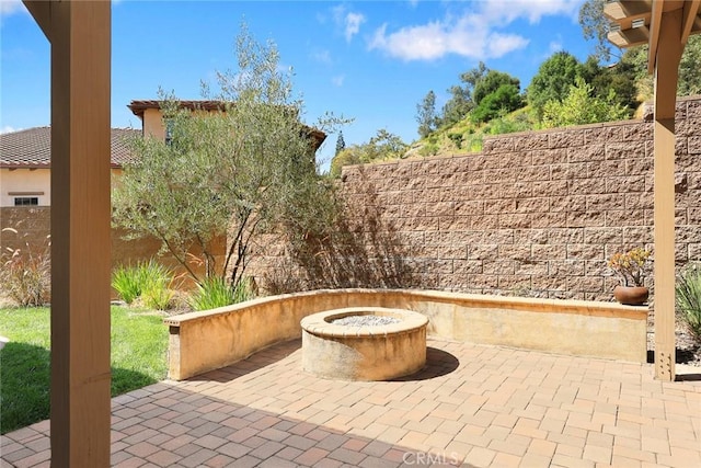 view of patio / terrace with fence and an outdoor fire pit