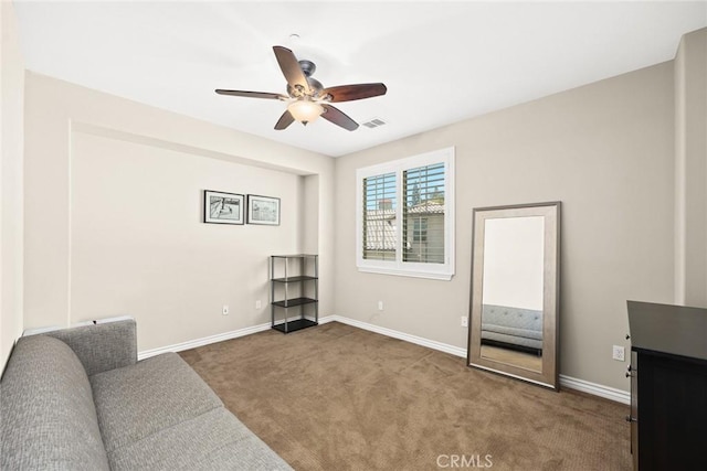 living area with visible vents, baseboards, ceiling fan, and carpet floors