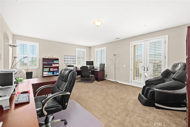 carpeted home office featuring visible vents, french doors, and baseboards