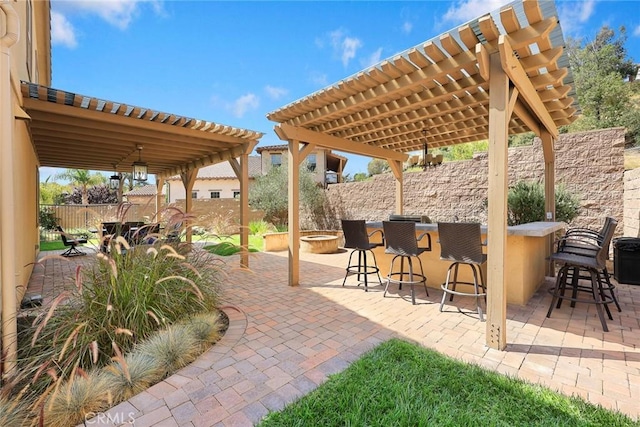 view of patio / terrace featuring fence, a pergola, and outdoor dry bar