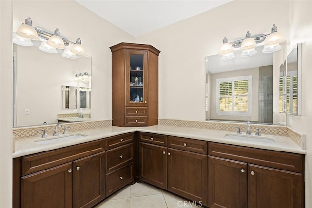 bathroom with tile patterned floors, decorative backsplash, and a sink