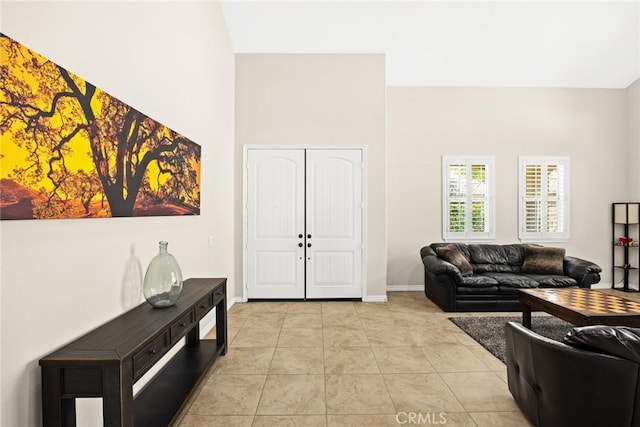 living area featuring light tile patterned floors and baseboards