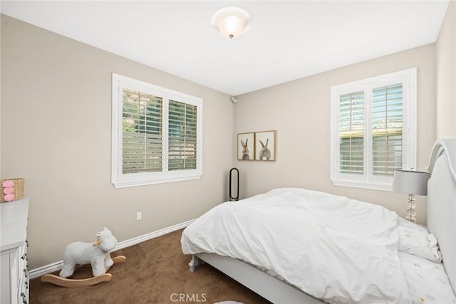 bedroom with baseboards and carpet