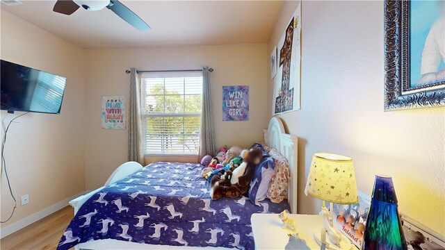 bedroom with ceiling fan and wood-type flooring