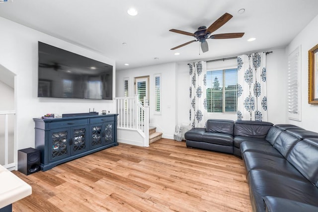 living room featuring ceiling fan and light hardwood / wood-style flooring