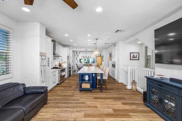 interior space with light hardwood / wood-style flooring and ceiling fan