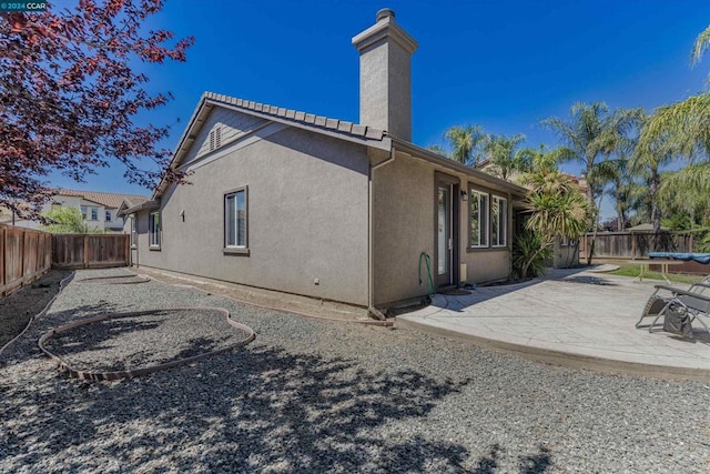 back of property featuring a patio