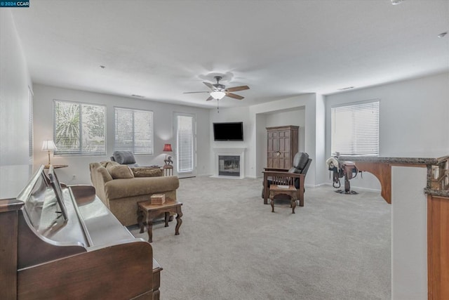 carpeted living room featuring ceiling fan