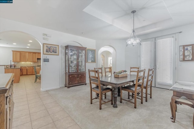 dining space featuring an inviting chandelier and light colored carpet