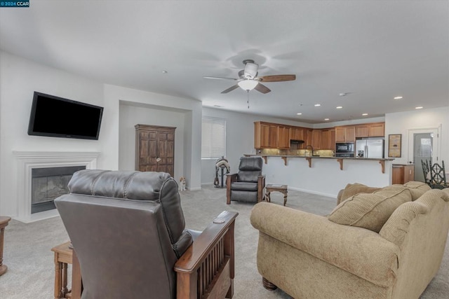 living room featuring light carpet and ceiling fan