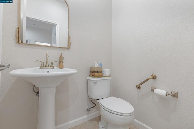 bathroom with tile patterned floors and toilet