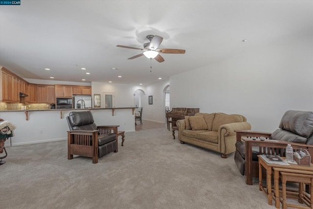 carpeted living room featuring ceiling fan