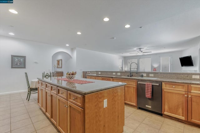 kitchen featuring light tile patterned flooring, a kitchen island, dishwasher, ceiling fan, and sink