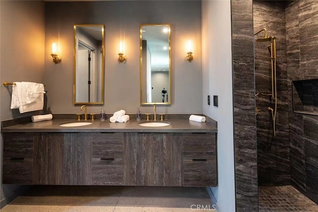 bathroom featuring a tile shower and vanity