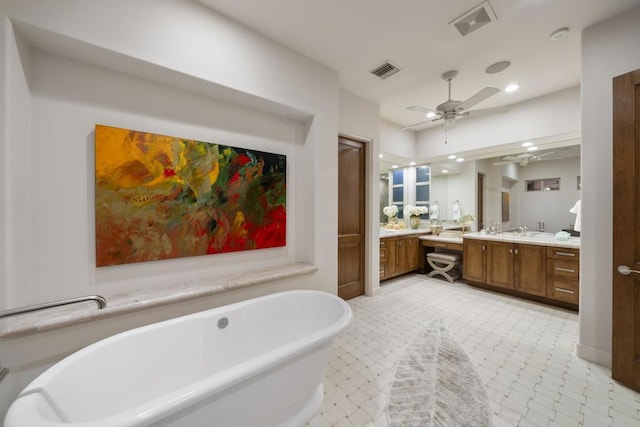 bathroom with vanity, ceiling fan, and a tub