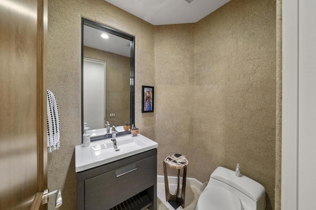 bathroom featuring toilet and vanity