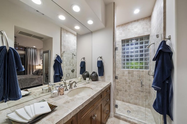 bathroom featuring an enclosed shower and vanity