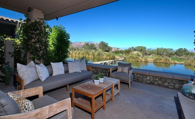 view of patio with an outdoor living space and a water view