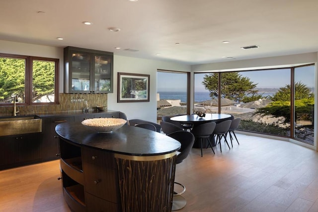 dining room with sink and light hardwood / wood-style floors