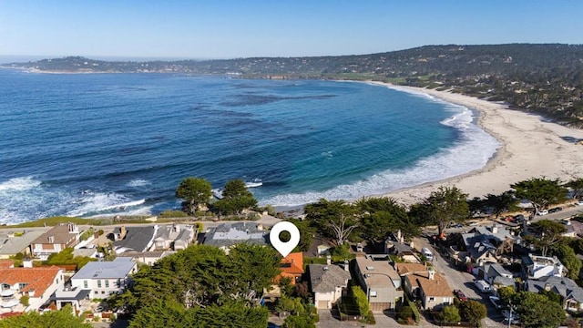 drone / aerial view featuring a water view and a view of the beach