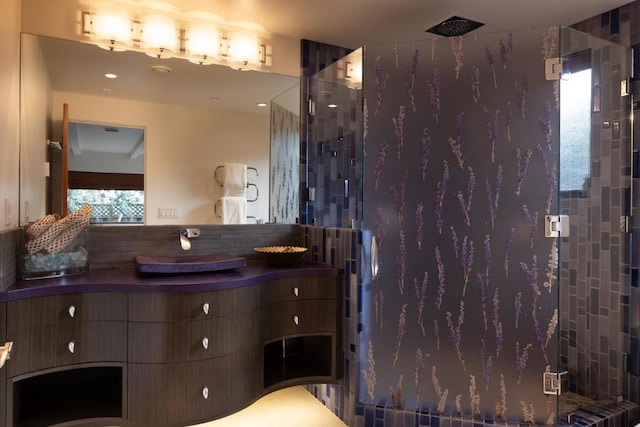 bathroom with vanity and tiled shower