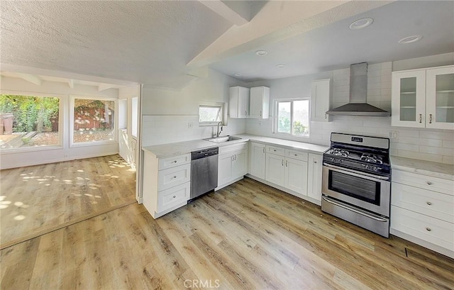 572 Church Hill Rd, La Habra Heights, CA 90631 - kitchen featuring appliances with stainless steel finishes, wall chimney range hood, light countertops, white cabinetry, and tasteful backsplash