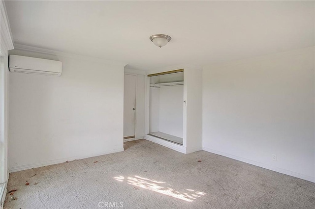 unfurnished bedroom with a wall unit AC, a closet, light colored carpet, and ornamental molding