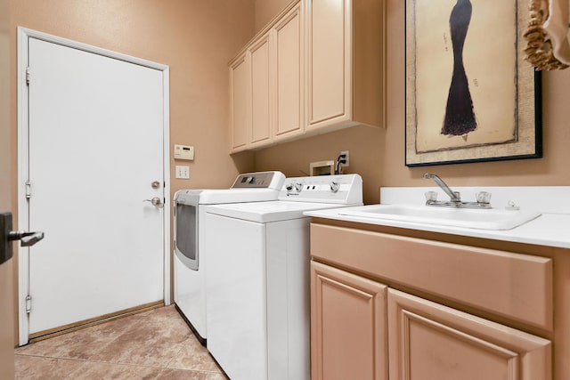 laundry area with cabinets, independent washer and dryer, light tile patterned flooring, and sink