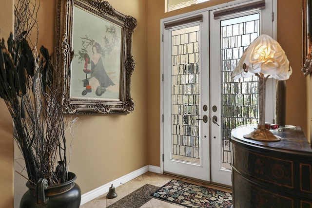 entryway with light tile patterned flooring and french doors