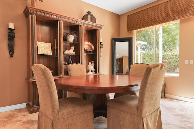 dining space with a healthy amount of sunlight and light tile patterned flooring