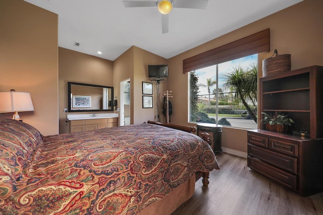 bedroom featuring light wood-type flooring, connected bathroom, and ceiling fan