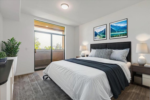 bedroom with dark hardwood / wood-style flooring and access to outside