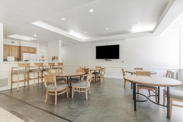 dining area with a tray ceiling