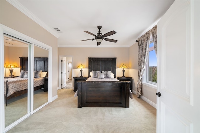 bedroom with crown molding, ceiling fan, and light colored carpet