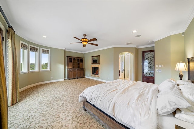 carpeted bedroom featuring ceiling fan and crown molding