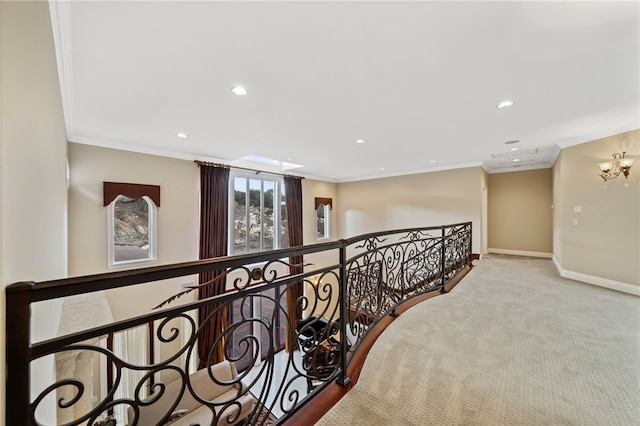 corridor featuring light colored carpet, an inviting chandelier, and crown molding