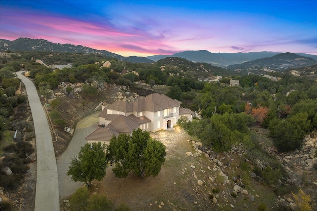 aerial view at dusk featuring a mountain view