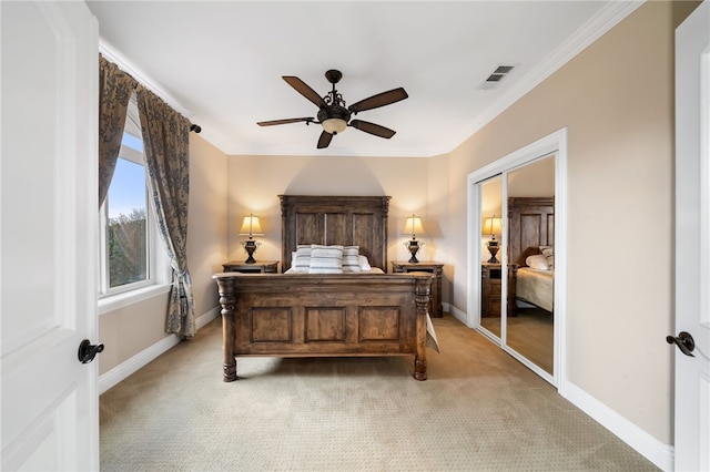 carpeted bedroom featuring a closet, ceiling fan, and crown molding