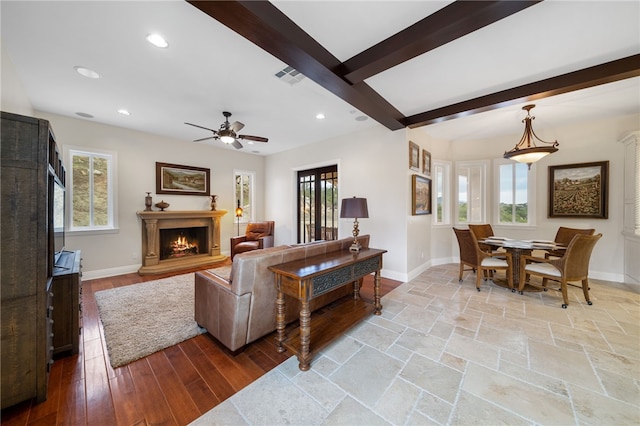 living room featuring ceiling fan, beamed ceiling, and hardwood / wood-style flooring